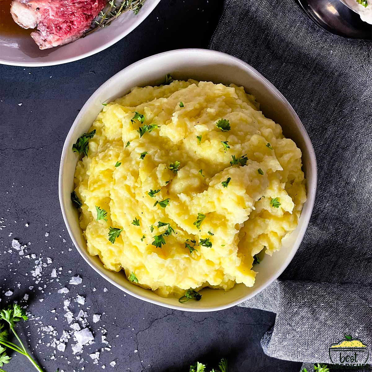Creamy garlic mashed potatoes in a bowl with chives