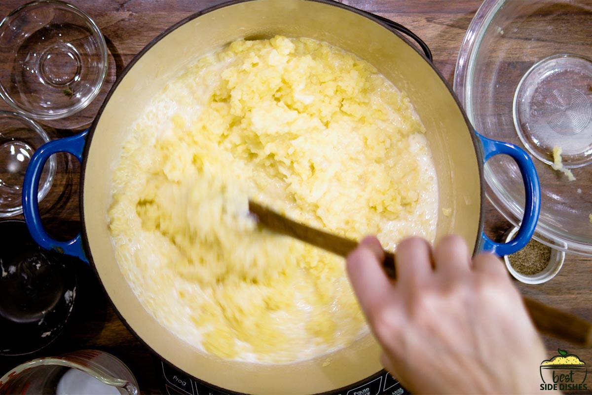 Stirring creamy mashed potatoes in a bowl