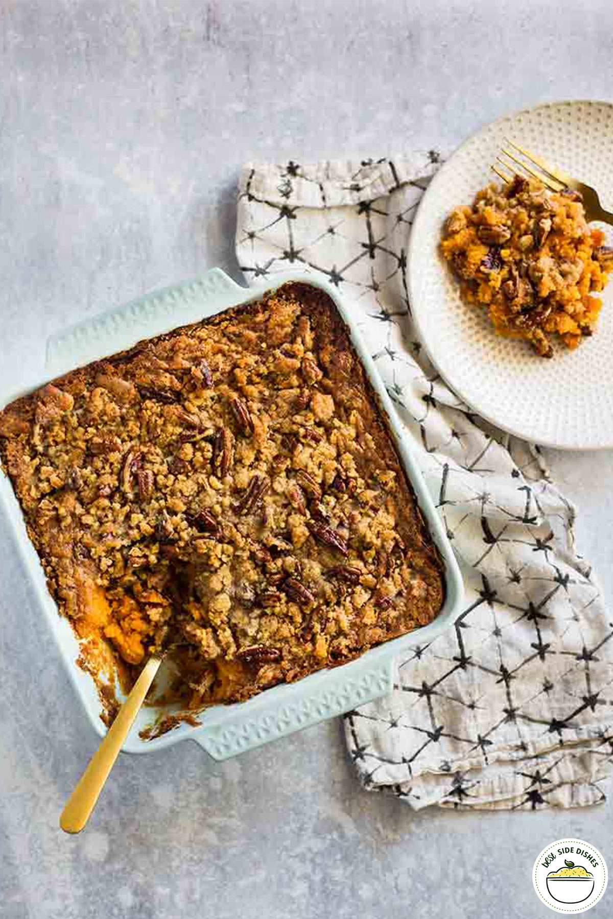 Sweet potato casserole in a dish next to a plate with a serving
