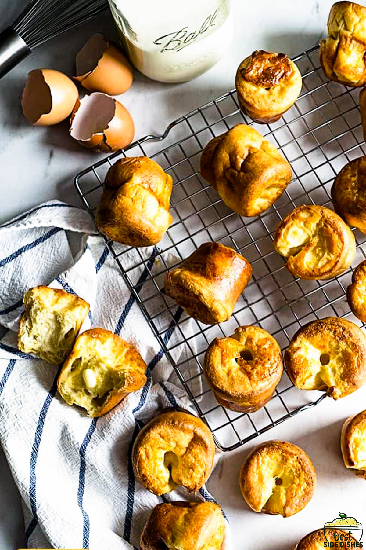 Yorkshire puddings on a rack next to milk and eggs