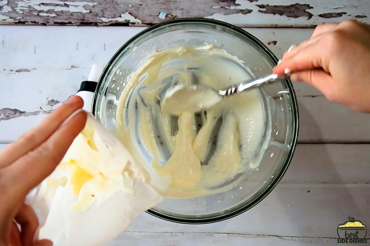 adding cream cheese filling to a piping bag
