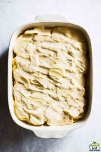 Potatoes covered with cream sauce in a baking dish