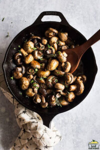 Button mushrooms in a cast iron skillet