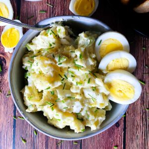 egg and potato salad in a bowl with a fork