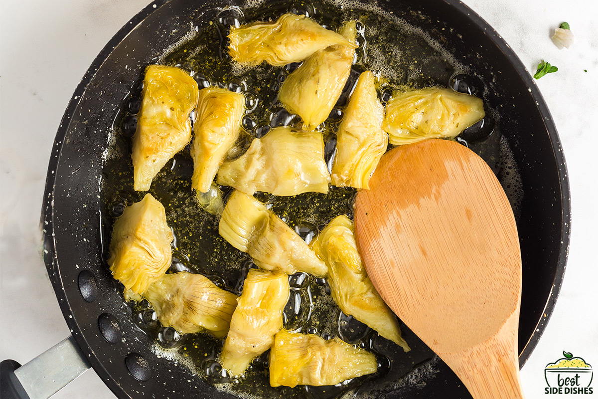 Roasting artichoke hearts in a pan