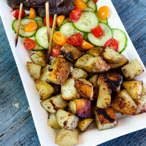 grilled potatoes with vegetables on a platter