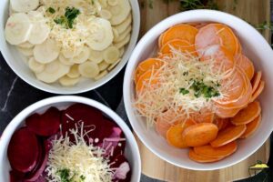 heavy cream and cheeses added to veggies in bowls