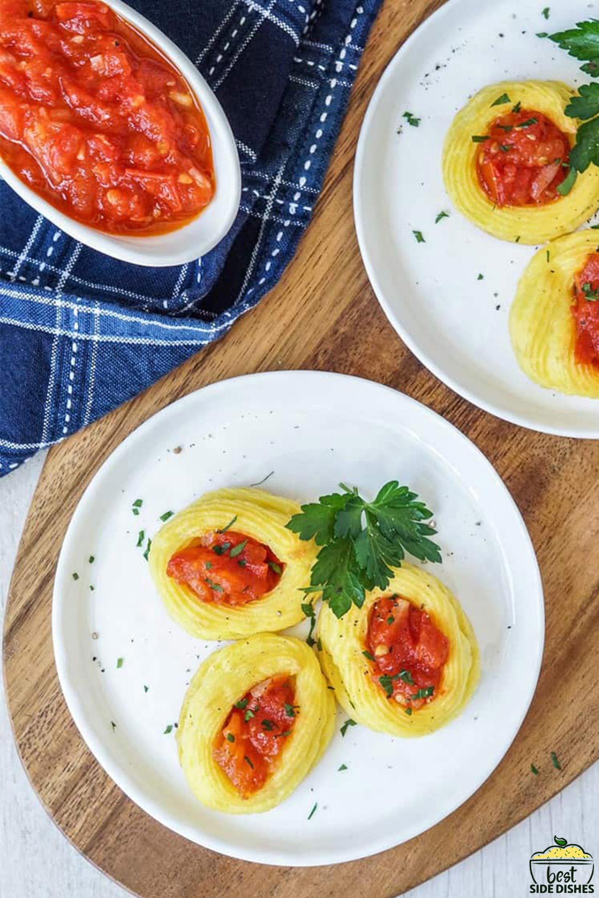 duchess potatoes on two plates with tomato sauce in a bowl