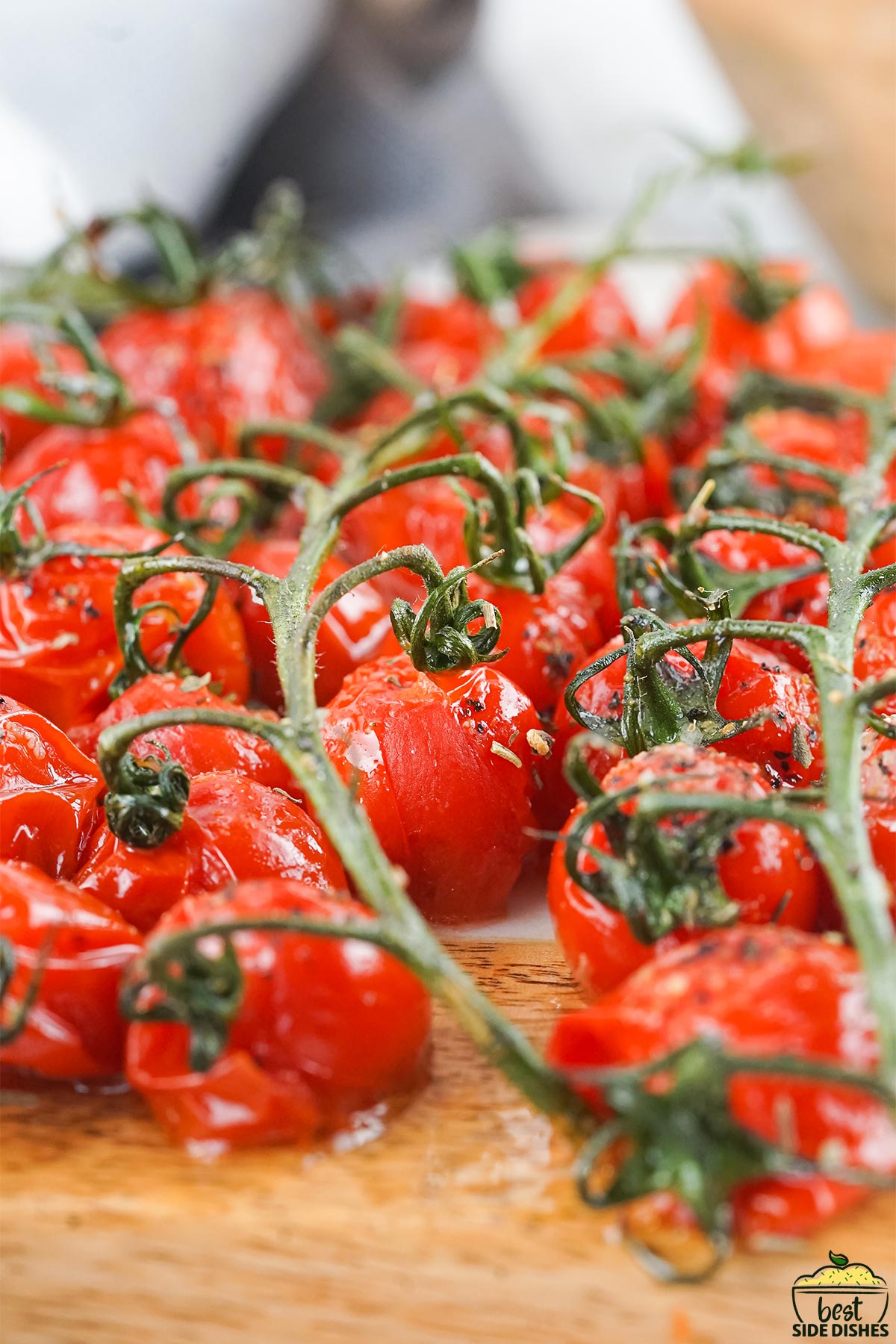 Roasted grape tomatoes on a cutting board