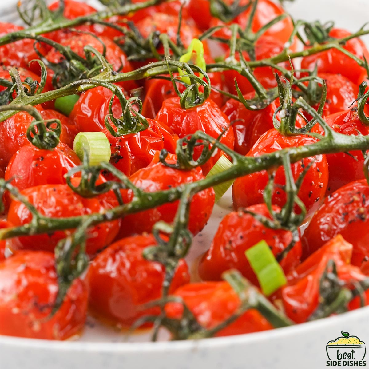 Roasted grape tomatoes in a white bowl