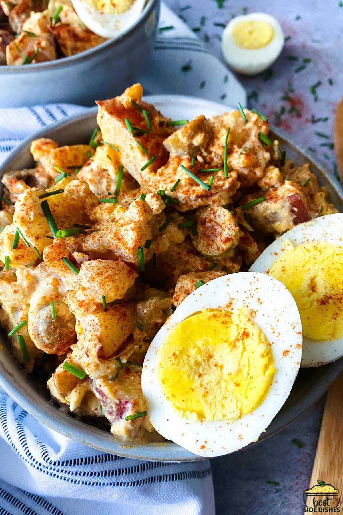 close up of spanish potato salad in a bowl with eggs