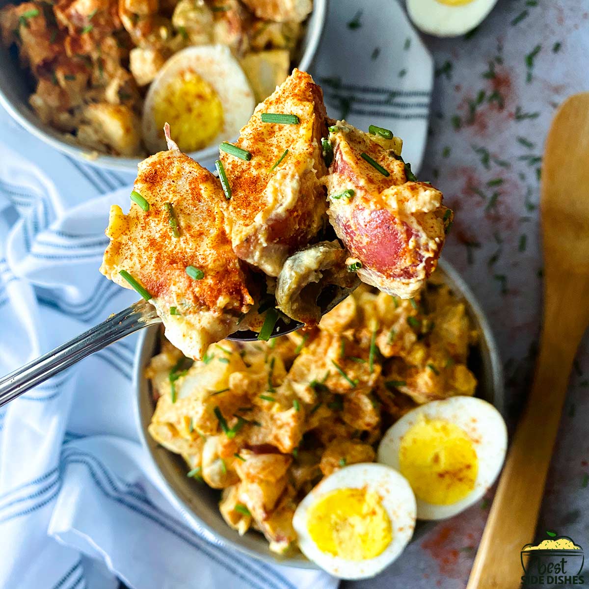 spanish potato salad in a bowl with slices of eggs