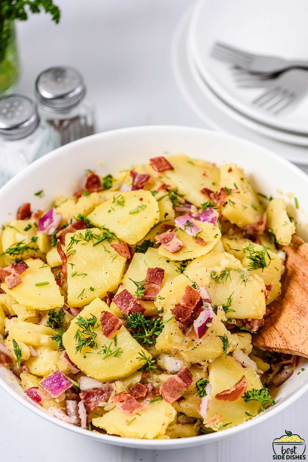 german potato salad in a white bowl up close