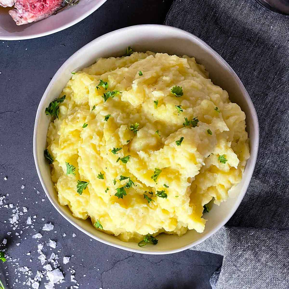 Buttery mashed potatoes in a white bowl