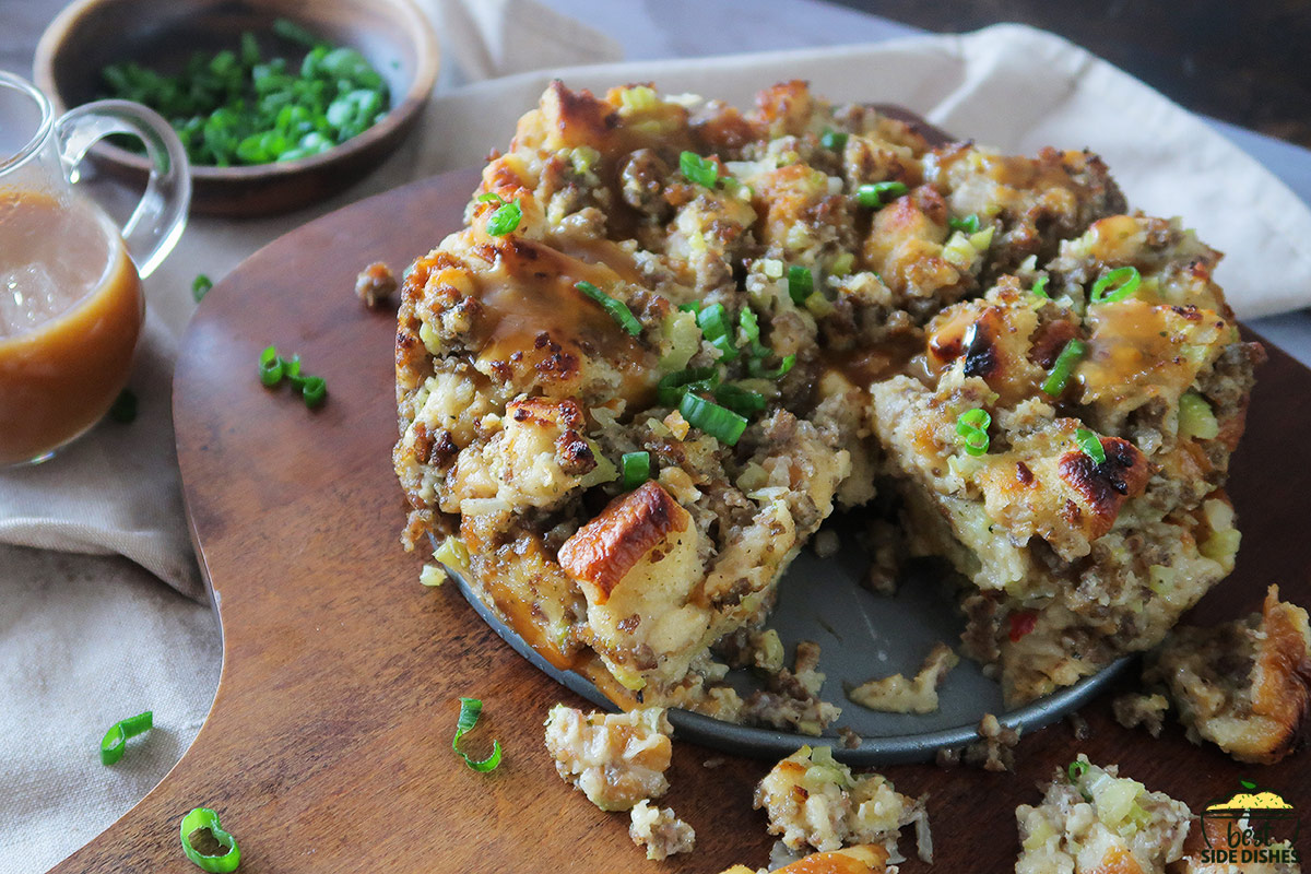 instant pot stuffing on a wood cutting board with gravy and green onions in the background