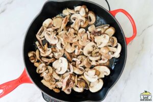 adding mushrooms to pan with butter