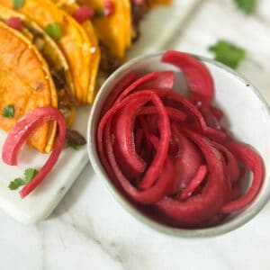red pickled onions in a grey dish