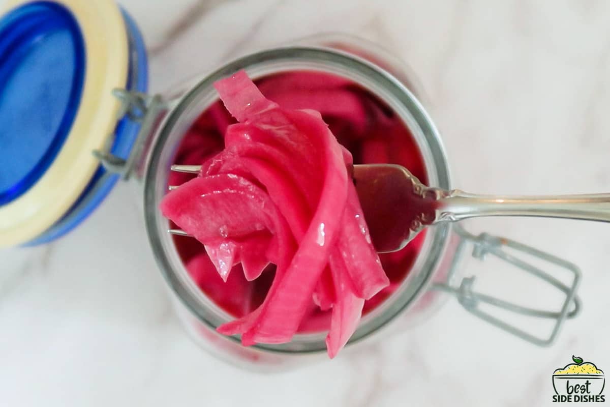 pickled red onions in a clear jar
